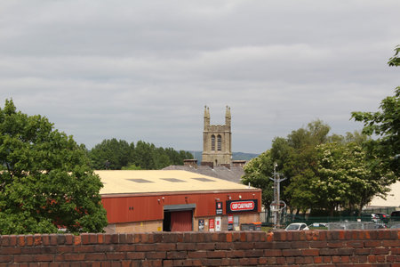 A view across town on a cloudy, grey day in the summer with the landscape dominated by the church...