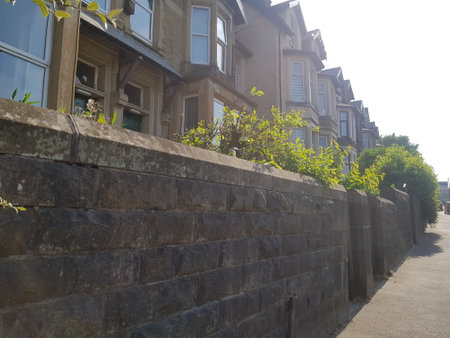 Sunlit view of town houses lining the main road into town on a bright summer day.の写真素材