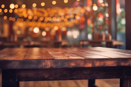 Empty wooden table in a restaurant with bokeh lights background.の素材