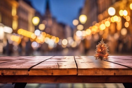 Empty wooden table and christmas tree in front of blurred background.の素材