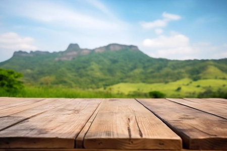 Wooden table top on blur mountain background with bokeh imageの素材