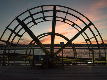 Old water wheel at the end of one of the Chelsea piers in Manhattan, New Yorkの写真素材