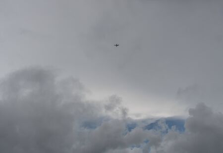 Stormy sky and a flying airplane on Oahu, Hawaiiの写真素材