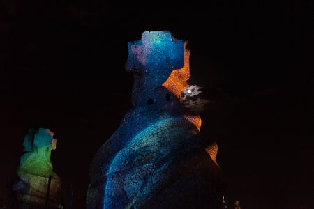 Beautifully illuminated rooftop structures at night in Barcelona, Cataloniaの写真素材