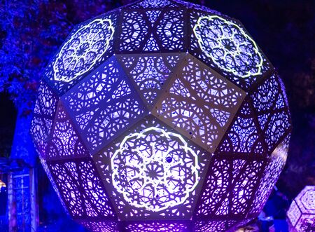 Enchanted forest of light - brightly illuminated intricate metal structureの写真素材
