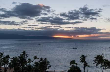 Beautiful Maui sunset with sun setting behind Lanai, Hawaiiの写真素材