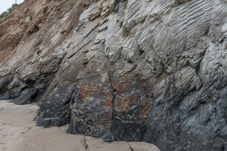 Natural oil seep at the bottom of the coastal cliff in Goleta, Southern Californiaの写真素材