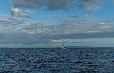 Beautiful ocean vista off the west coast of Maui with a sailboat in the foreground and Kahoolawe...