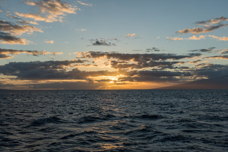 Beautiful sunset on Maui with sun setting between Lanai and Molokai islands, Hawaiiの写真素材