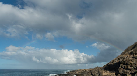 Beautiful rainbow viewed from the Kaena Point trail on Oahu, Hawaiiの写真素材