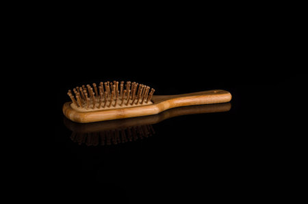 Barber wooden hair comb on black background