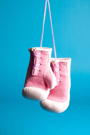 Souvenir pink boxing gloves isolated on blueの写真素材