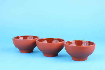 Arabian old ceramic brown teacups isolated on blueの写真素材