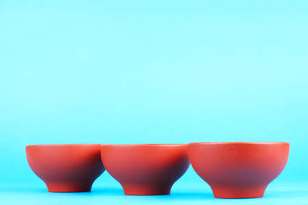 Arabian old ceramic brown teacups isolated on blueの写真素材