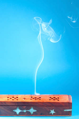 Smoke of Tibetan incense on the blue backgroundの写真素材