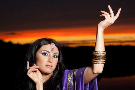 Beautiful indian brunette young woman with traditional fashion on sunsetの写真素材