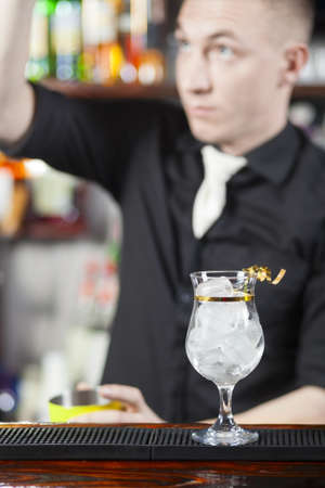 Bartender is making cocktail at bar counterの写真素材