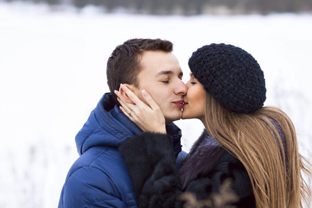 Happy Young Couple in Winter field having fun.