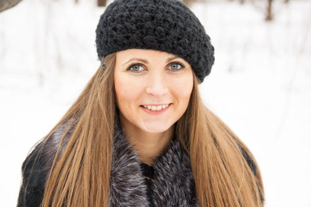 Beautiful dark blond haired girl in winter park