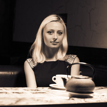 pretty woman in cafe sitting alone have a cup of teaの写真素材