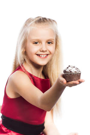 Girl giving at cake. Isolated on white background.の写真素材