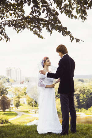 Bride and groom standing on a hillの写真素材