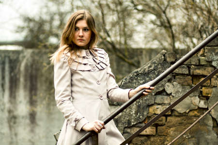 Girl is standing on the old stepsの写真素材