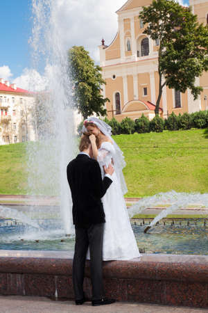 Bride and groom standing together. Bride overwhelmed with emotionの写真素材