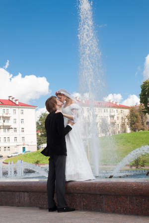 Bride and groom standing together under the blue skyの写真素材