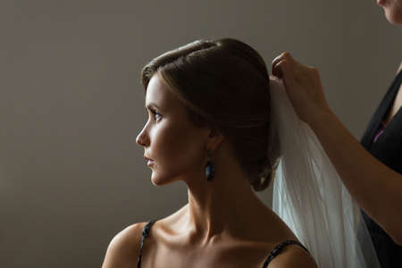 Beautiful caucasian bride getting ready for the wedding ceremonyの写真素材