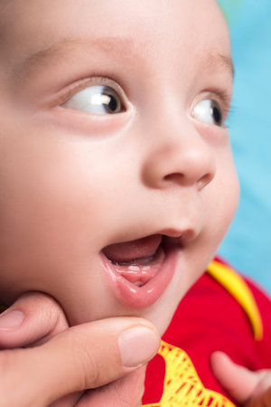 Beautiful cute baby shows the calf's teeth
