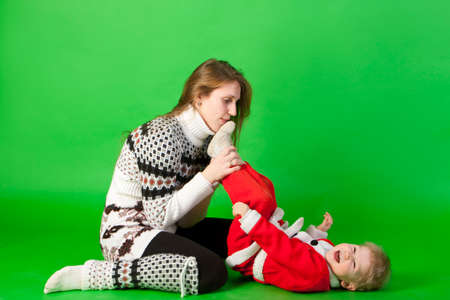 Father and son wearing Santa costume play togetherの写真素材