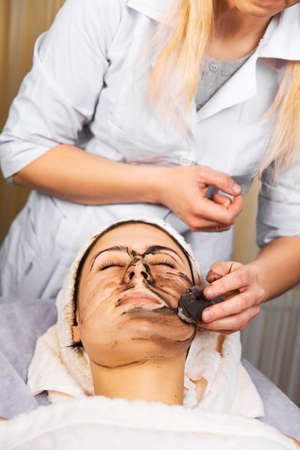 skin care, medical beautician removes the mask from the face of the girlの写真素材