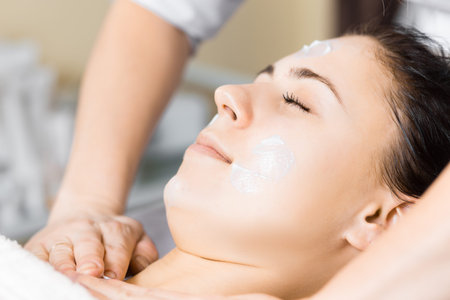 skin care, medical beautician makes massage face after applying mask