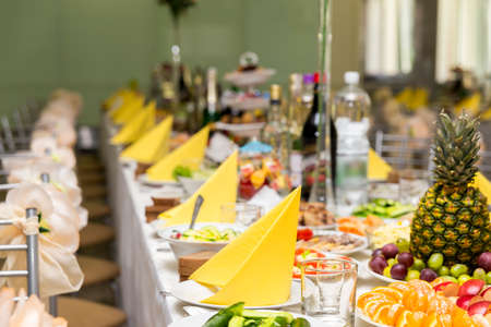 Served for a banquet table. Wine glasses with napkins, glasses and salads.の写真素材