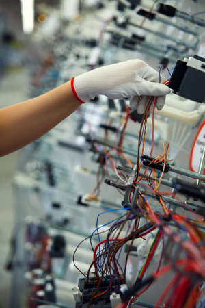 Hands employee that manufacture the wiring for the carの写真素材