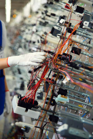 Hands employee that manufacture the wiring for the carの写真素材