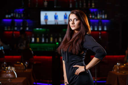 pretty young woman in nightclub standing aloneの写真素材