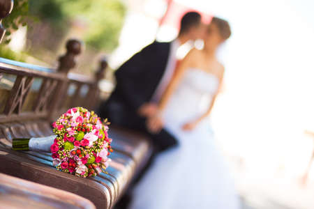 Bride and groom with bridal bouquet in frontの写真素材