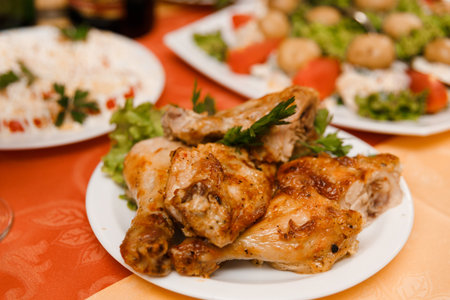 Plate with roasted chicken on holiday tableの写真素材