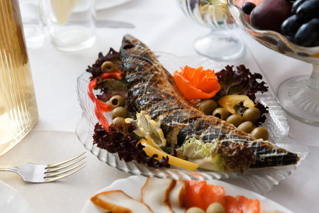 Large stuffed pike with vegetables on the tableの写真素材