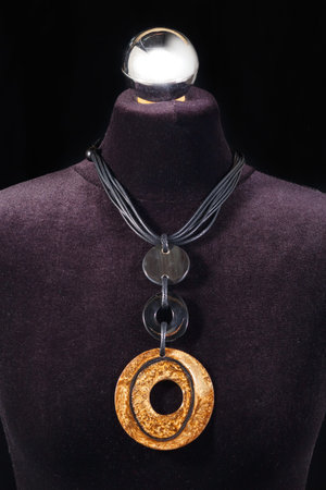 Leather necklace and stone on black mannequinの写真素材