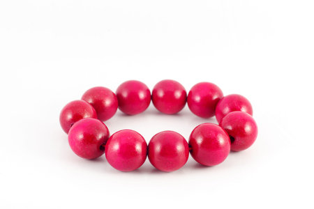 red wooden beads bracelet isolated on whiteの写真素材