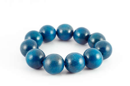 blue wooden beads bracelet isolated on whiteの写真素材