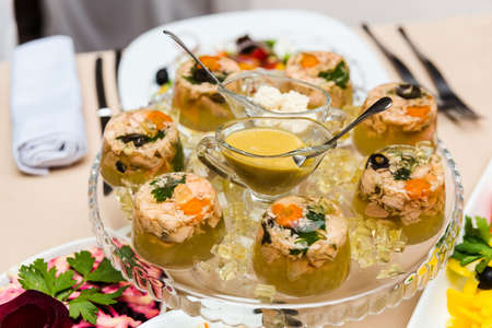 Aspic from meat decorated with parsley on a festive tableの写真素材