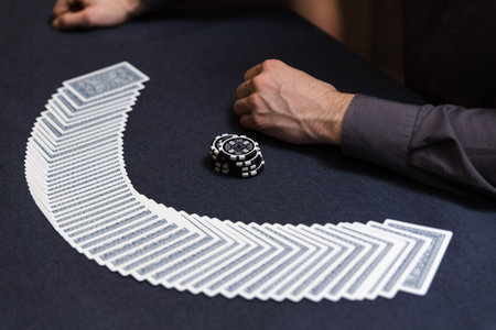 Dealer spreading the deck at poker game in casino