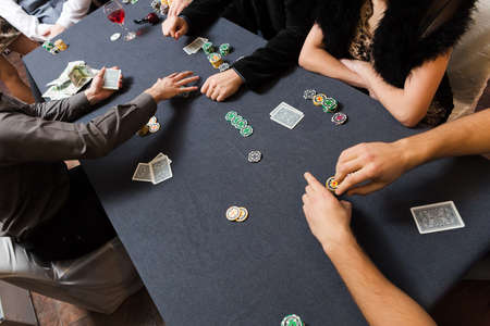 People playing poker. Players hands on table.の写真素材