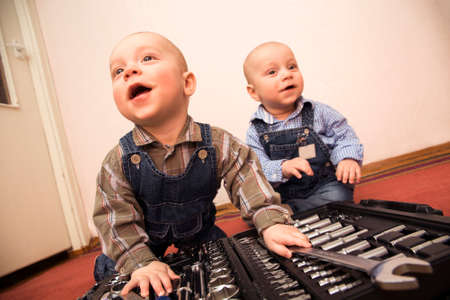 Two little boys plays construction worker at homeの写真素材