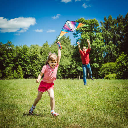 Dad devotes time to the child. Father playing with his daughter. Sky kite.の写真素材
