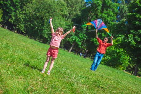 The girl and her father play with a kite. Dad devotes time to the child.の写真素材